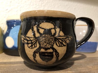 Mug with a hand-carved honeybee illustration