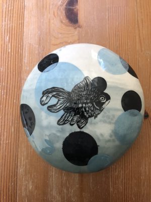 Round dish with a goldfish illustration and polka dots