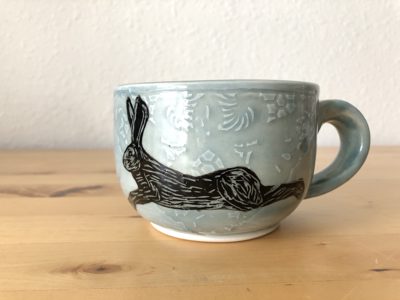 Mug with an illustration of a resting hare