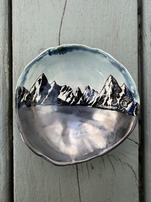 Dish with a mountain landscape illustration