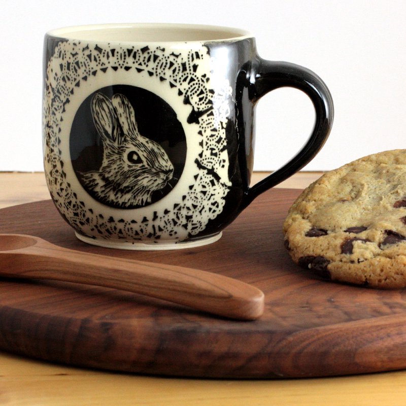 Mug with a bunny illustration served with a cookie