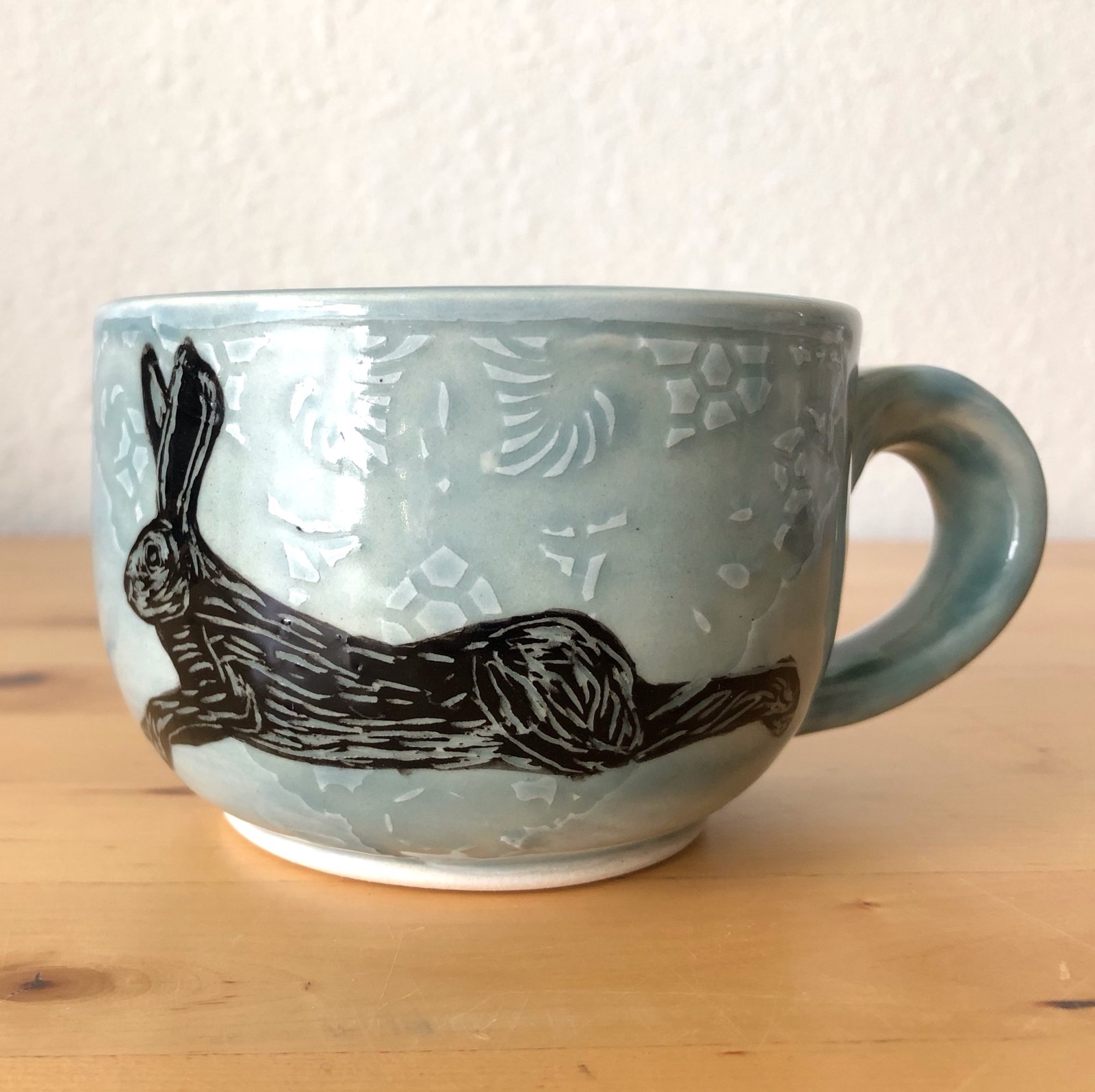 Mug with a resting hare illustration